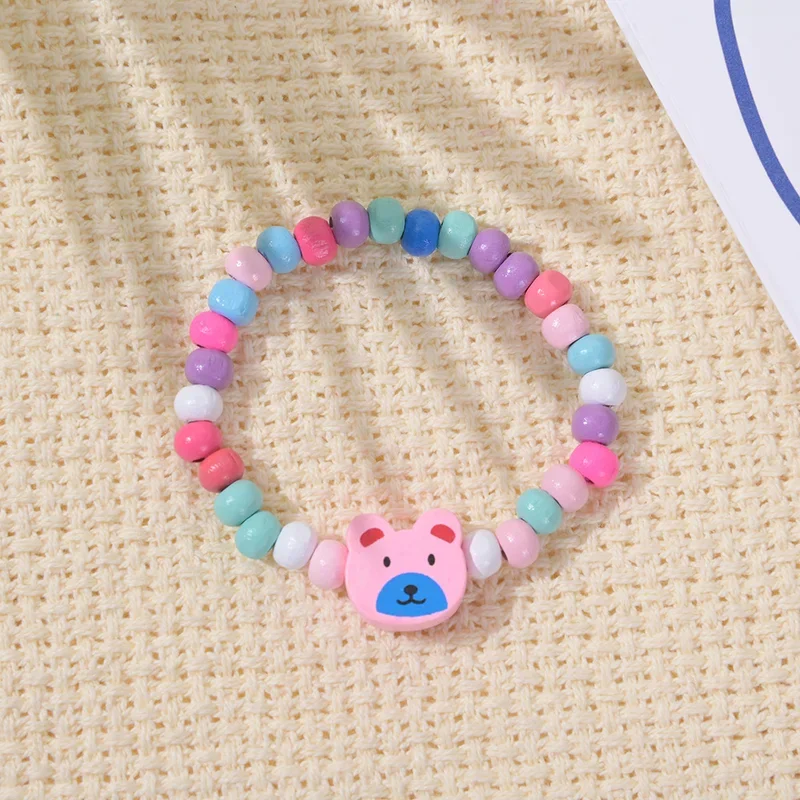 12 sztuk/opakowanie Kolorowe bransoletki z drewnianymi koralikami z motywami z kreskówek dla dziewczynek, upominki na przyjęcie urodzinowe, prezenty dla gości na baby shower, wypełniacze do piñaty — zdjęcie 4