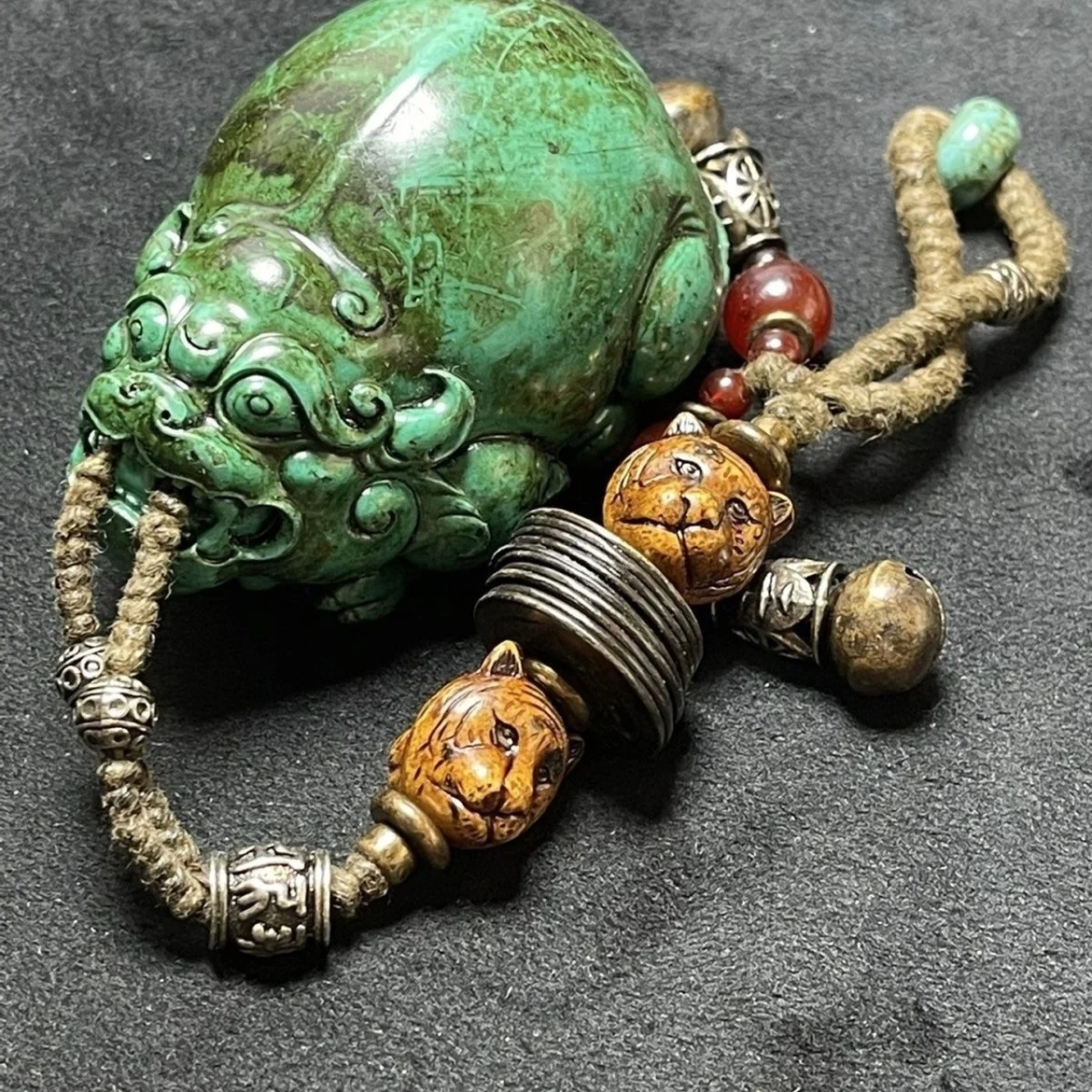 

Antique turquoise animal pendant with Tibetan silver bells, copper coins and agate ornaments.