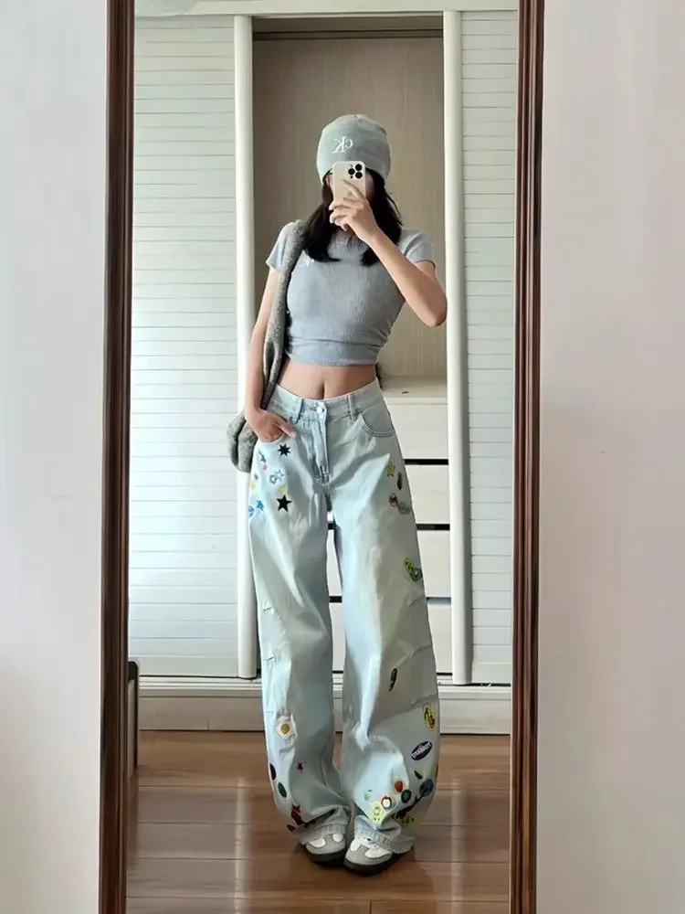กางเกงยีนส์ทรงหลวมพิมพ์ลายการ์ตูนสีน้ำเงินวินเทจ สไตล์ Y2K สำหรับผู้หญิง ฤดูใบไม้ร่วง 2025 สไตล์ฮาราจูกุ ขากว้าง เอวสูงทรงโอเวอร์ไซส์ ยุค 2000
