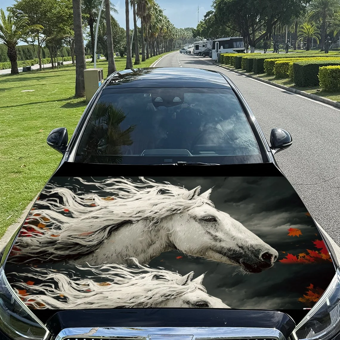

Elegant white horse design on car hood, featuring flowing mane and autumn leaves against a dark sky backdrop.