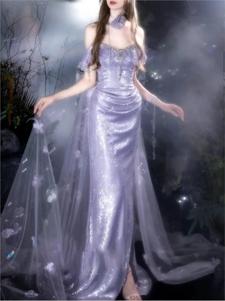 A light purple host toasts one-shoulder model walking the runway beaded into dress
