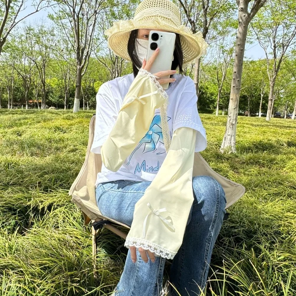 น่ารักโบว์ผ้าไหมน้ําแข็งแขนแขนสีทึบ Flared ครีมกันแดดแขนแขน UV ป้องกันลูกไม้ขี่จักรยานแขนสาว