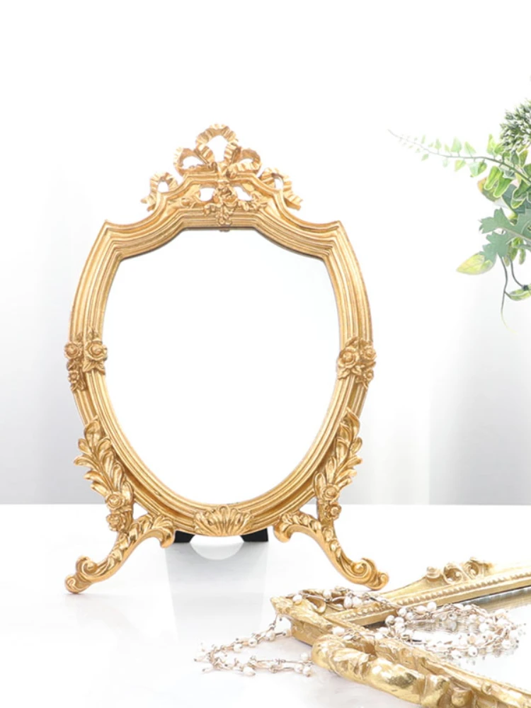 

Light luxury palace style retro French carved style gilt hollow bow embossed makeup mirror vanity mirror ornaments