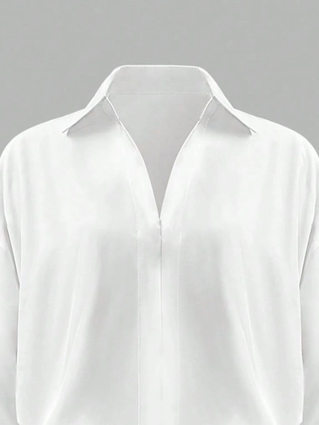 Oversized solid-colored jumpsuit with long sleeves in a versatile shirt style