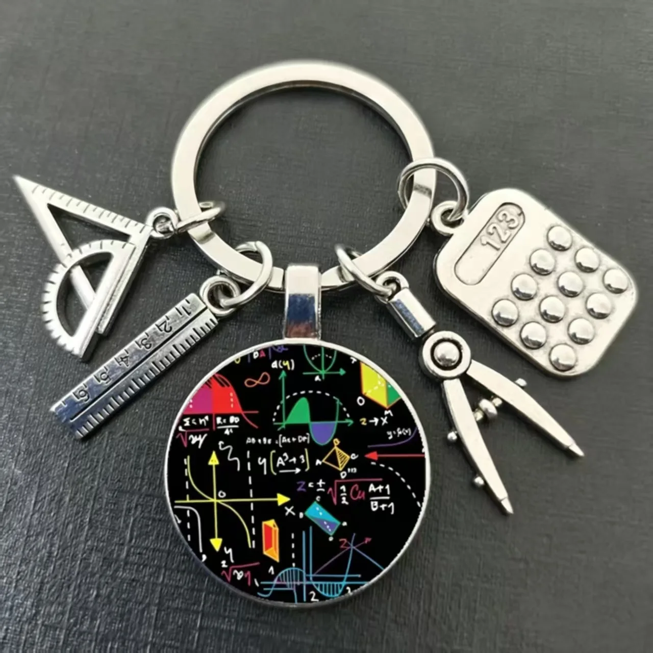 Innovative student math keychain featuring a set square, ruler, compass, and calculator design, perfect as a daily accessory