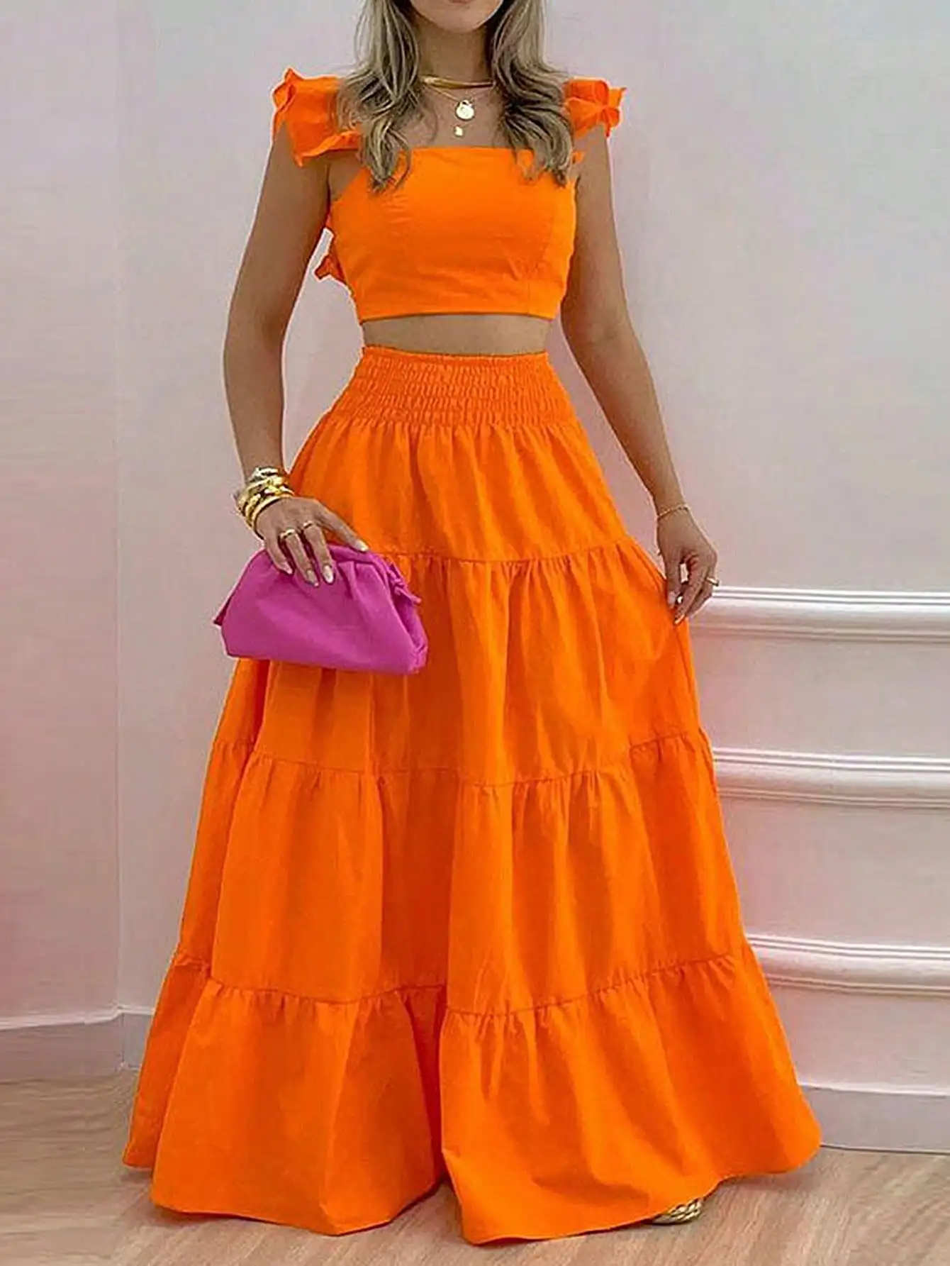 

Оранжевый комплект из укороченного топа с открытыми плечами и многоярусной макси-юбки