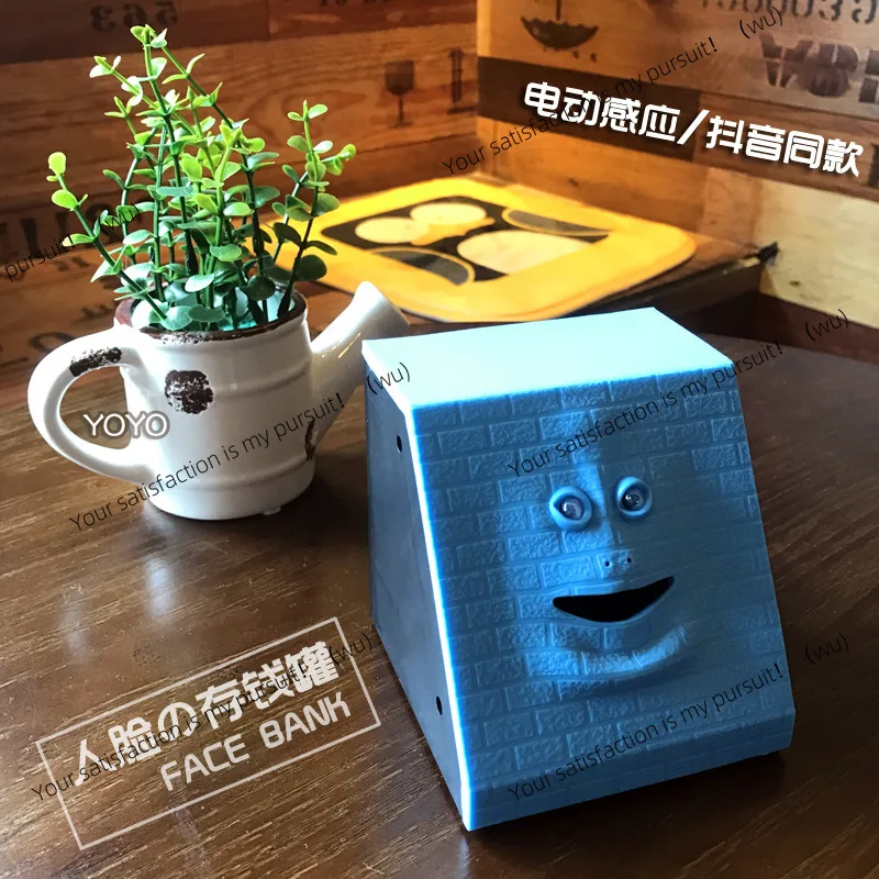 وجه مبتكر على شكل حصالة على شكل خنزير يستشعر الوجه الذي يتحرك عند تناول الأموال، يمكن أن يتحرك فم وجه القرد على شكل خنزير