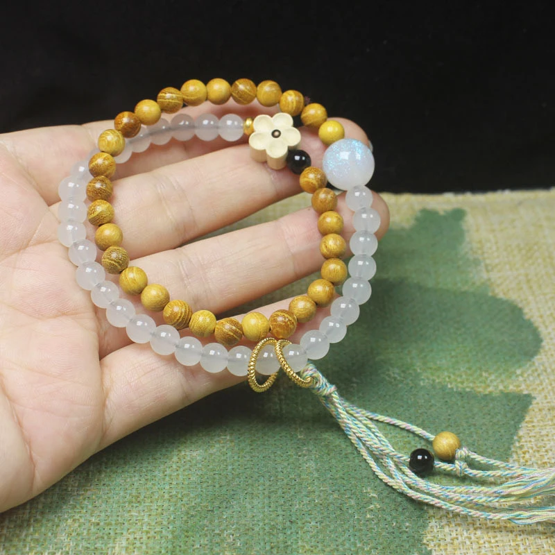 

Golden Wood 6mm Plum Blossom Double Ring Buddhist Bead Bracelet with Cotton Rope Tassel and Decorative Beads