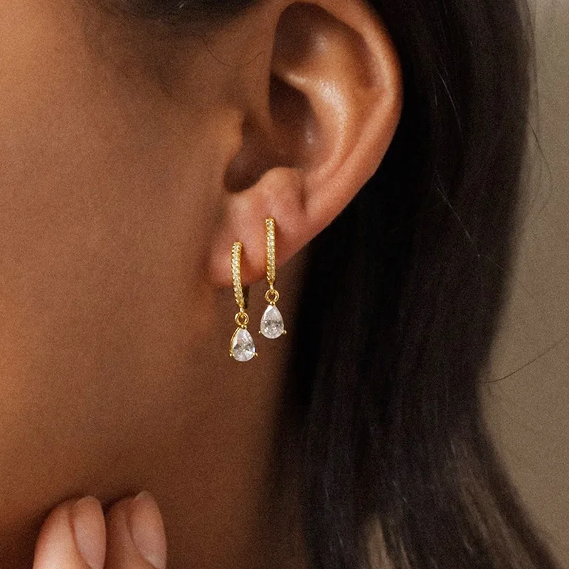 

Golden earrings, female droplet shaped circular earring, fashionable daily outfit