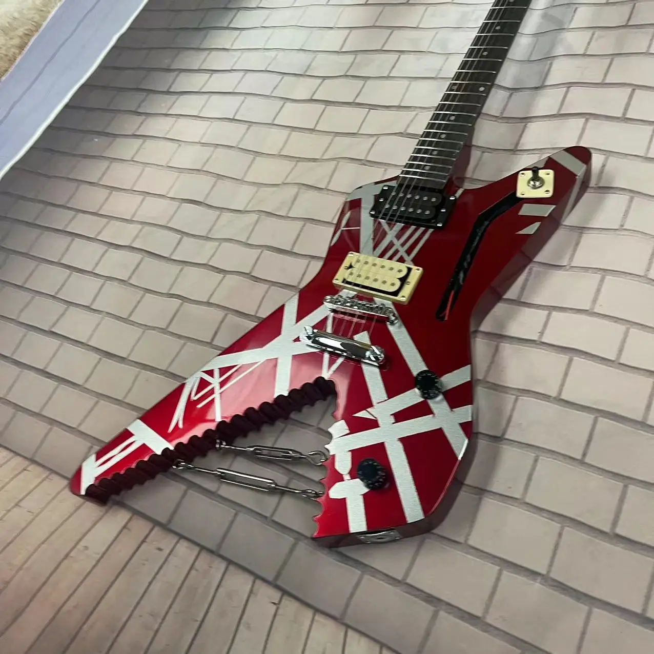 A unique 6-string electric guitar with a metal red striped pattern on the body, high gloss, rose wood fingerboard, maple track,