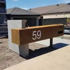 Red metal mailbox, modern mailbox, corten steel letter box with hanging wall planter