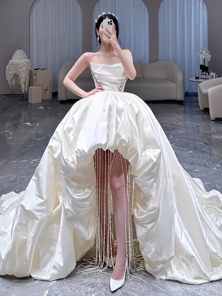 

A strapless dress with puffy white tassels and few pearls giving high-end