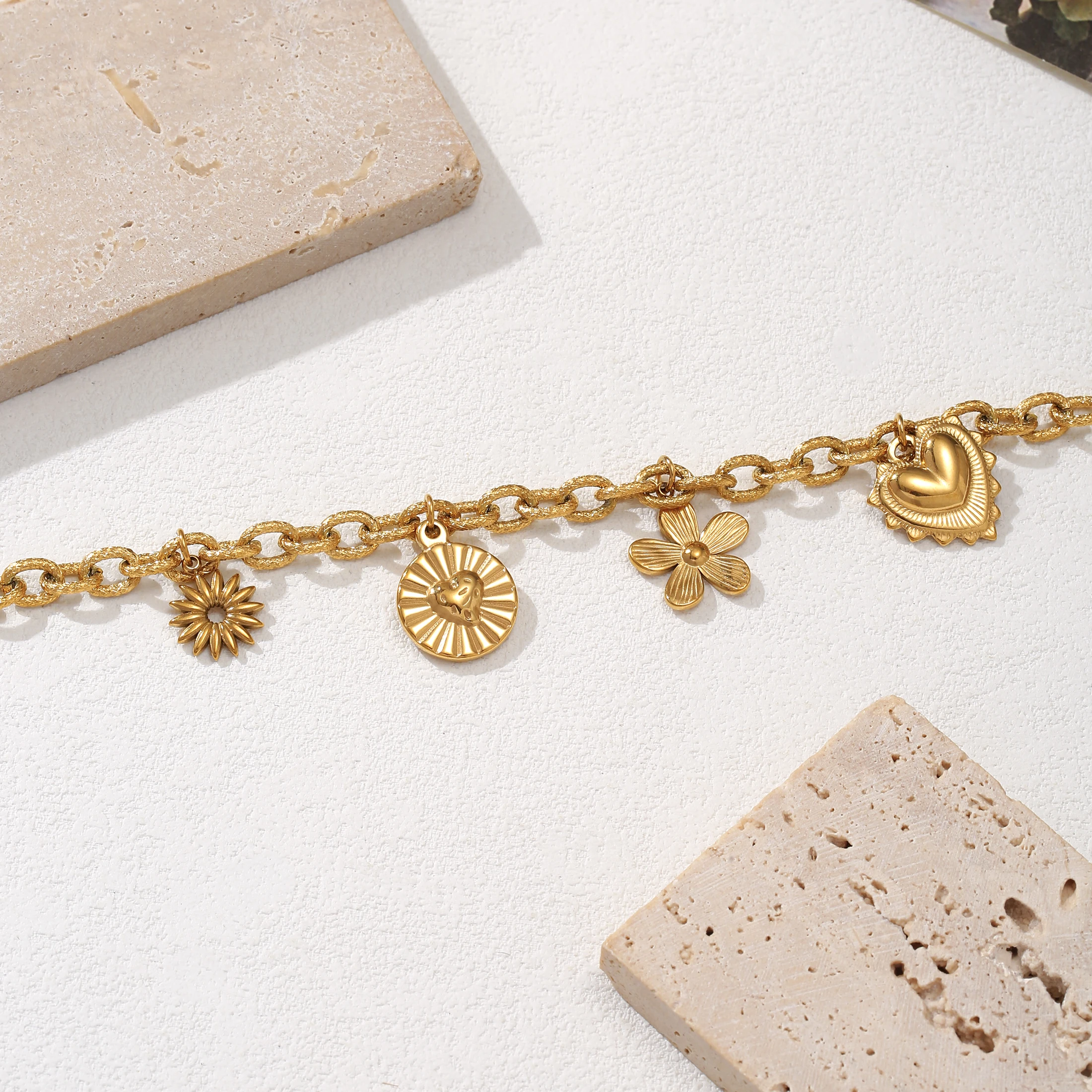 

Golden Tone Stainless Steel Multi-Charm Bracelet with Heart and Flower Charms for Women