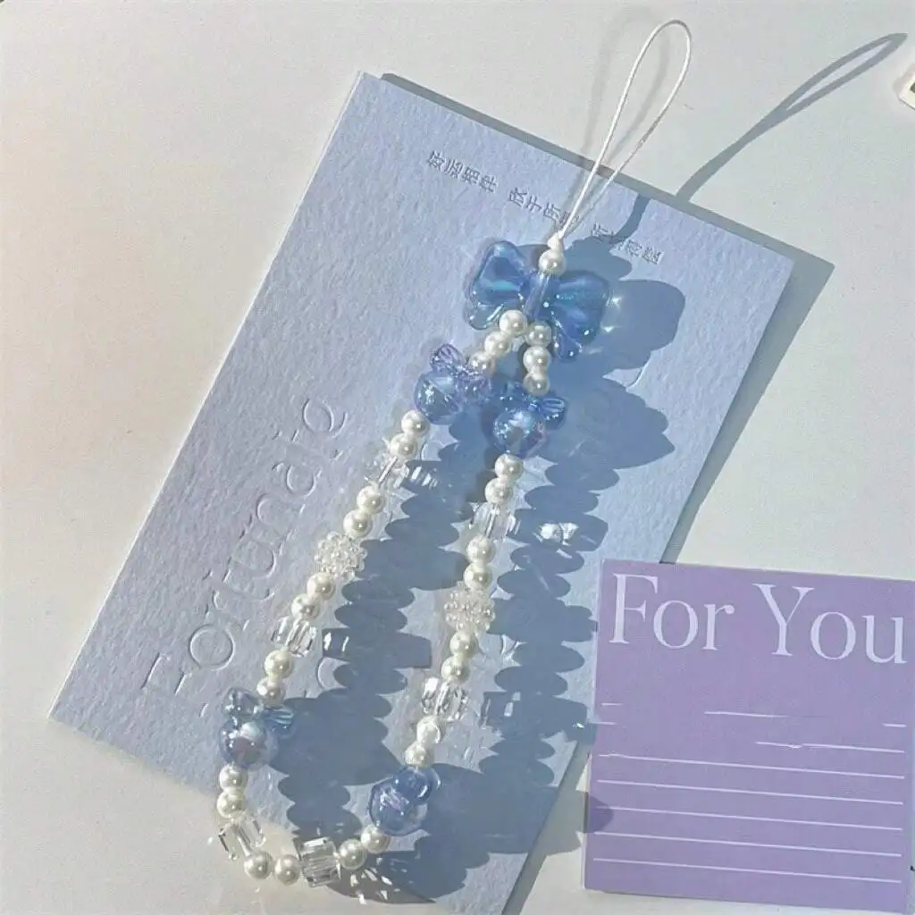 

Брелок для телефона с бантом из хрустальных бусин