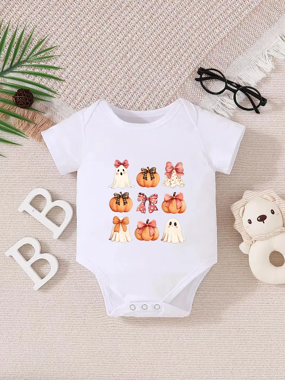 Playful letter-printed baby short-sleeve triangle bodysuit. Button closure for easy dressing, machine washable