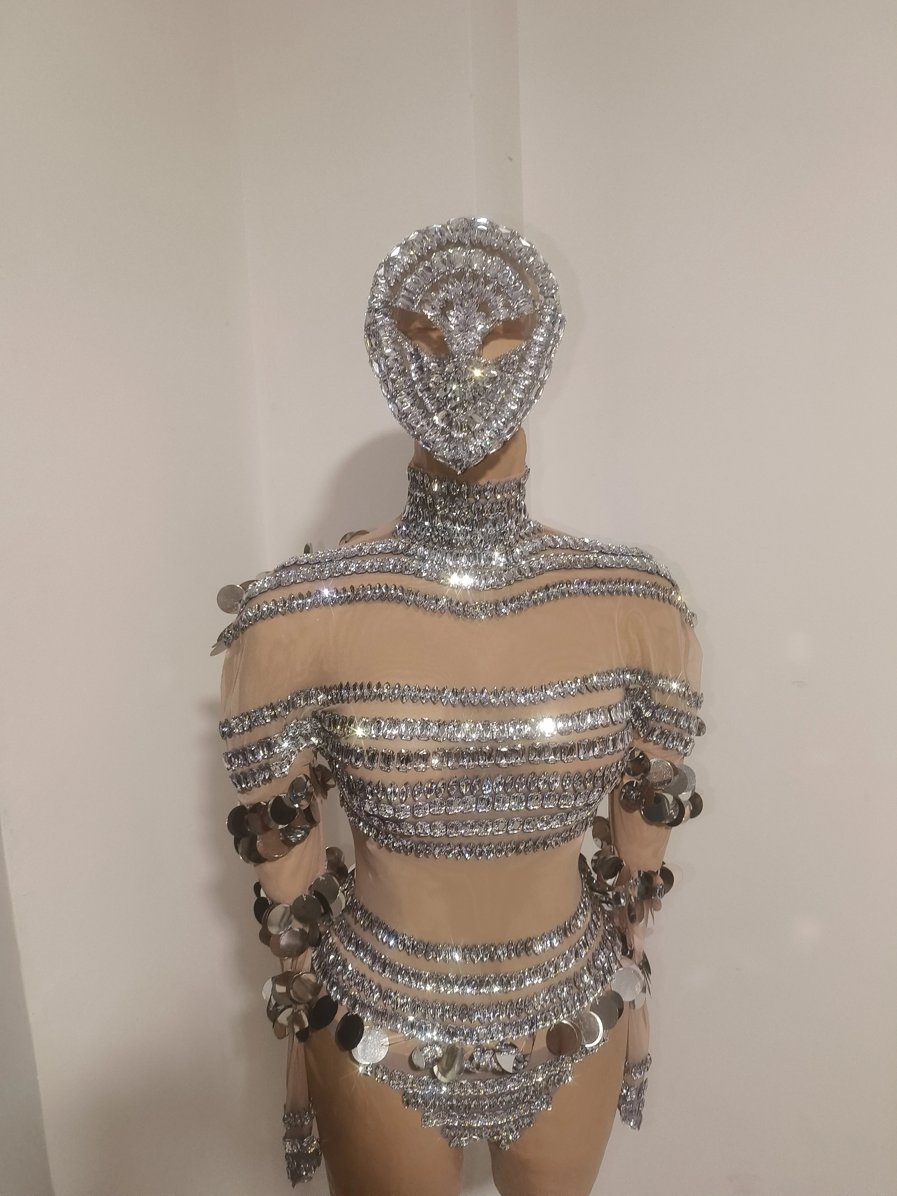 Lady's luxurious and alluring semi-transparent sequined jumpsuit, paired with a droplet-shaped mask - a Latin dancer's outfit
