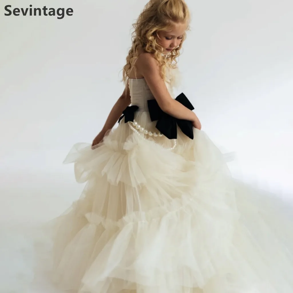 

Платье для девочек в стиле Хепберн от Sevintage: многоярусная юбка из тюля цвета шампань, черный атласный бант, жемчужная цепочка, нарядное платье для конкурсов, пошив на заказ