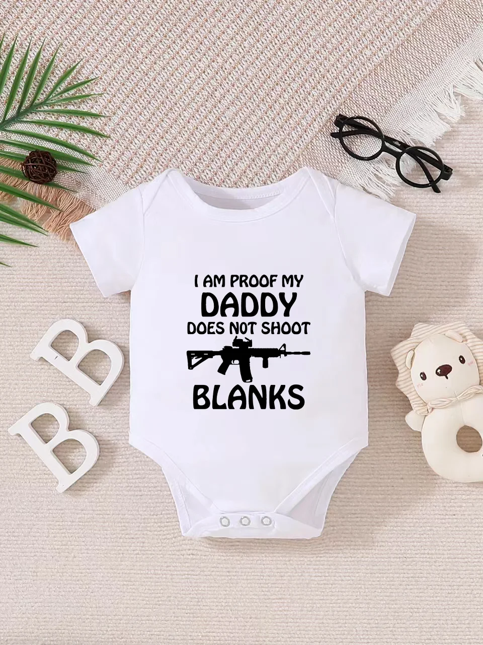Playful letter-printed baby short-sleeve triangle bodysuit. Button closure for easy dressing