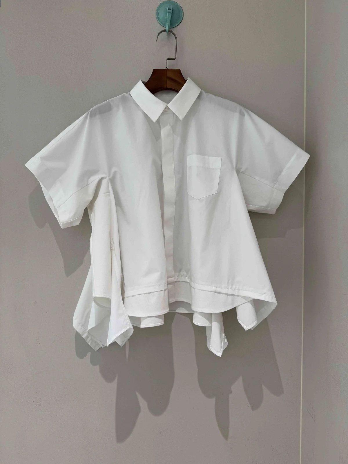 

2026 Spring New Minimalist Fashion American Style Heavy Industry Splicing Irregular Polo Collar Design Shirt For Women