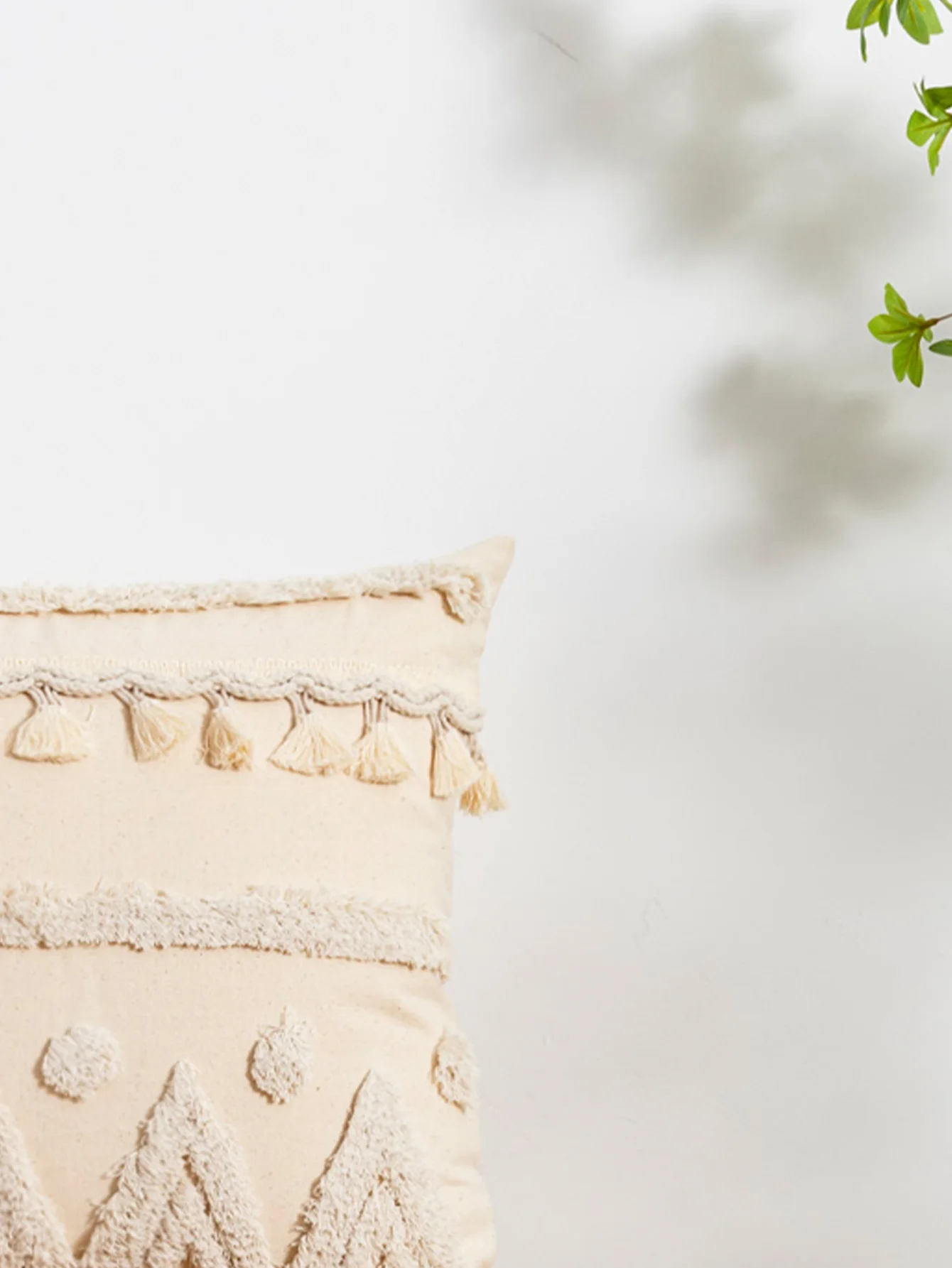A beige triangular dot tassel pillow cover with European and American style tufting technology used for sofas, beds, bedrooms