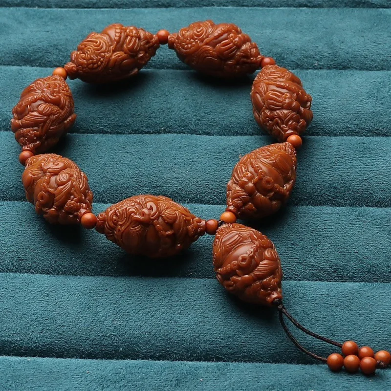 

Factory Direct Supply Olive Nut Jadified Material Hand Carved Eight Treasures Golden Bracelet Stone Carving Fortune Crafts