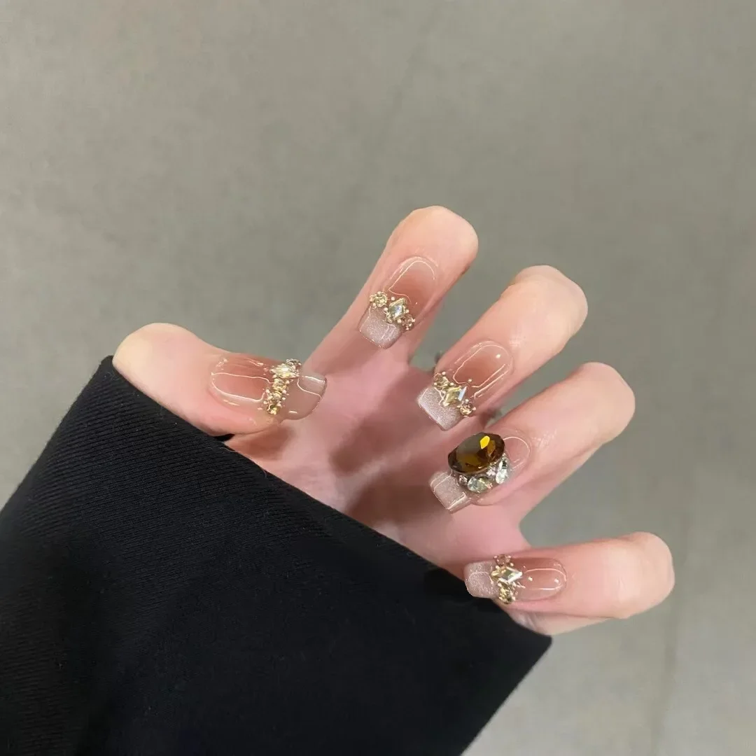 

10pcs Press-On Nails Set Nude&Golden Trapezoid Short Nails with Pearlescent Glitter Cat-Eye French Tip Black Rhinestones Nails