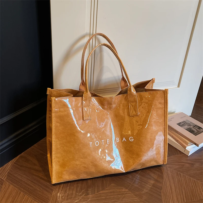 

2026 New Women's Waterproof PVC Tote Transparent Jelly Handbag for Commute Beach Travel Durable Kraft Paper Style Shoulder Bag