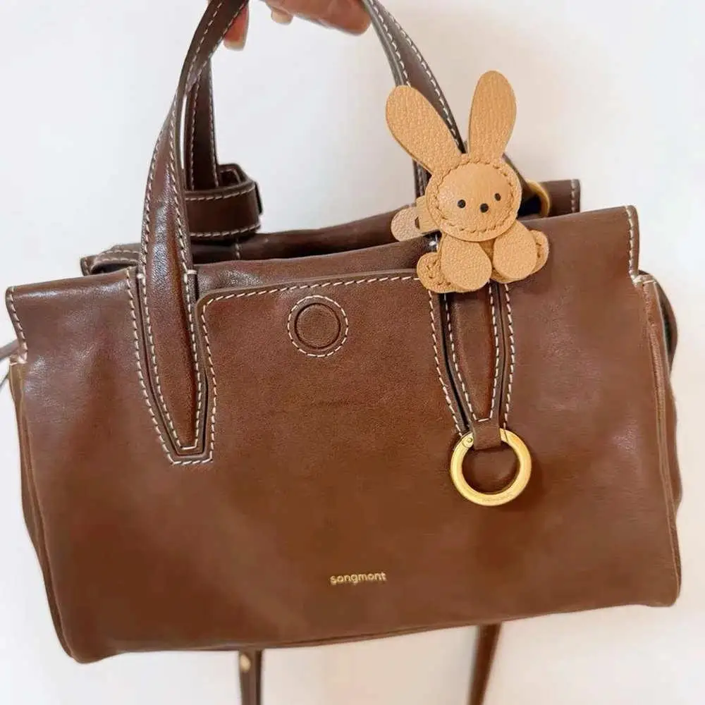 2025 لطيف الأرنب قلادة حقيبة سلسلة مفاتيح الحلي لطيف الجلود حقيبة ساحرة اكسسوارات الديكور كيرينغ الفتيات الهدايا اليدوية