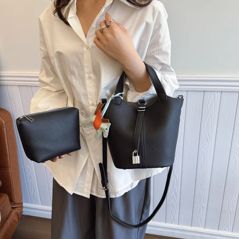 

Fashion handbag, unique bucket classic shopping handbag, soft PU lychee pattern basket women's bag, with pony pendant