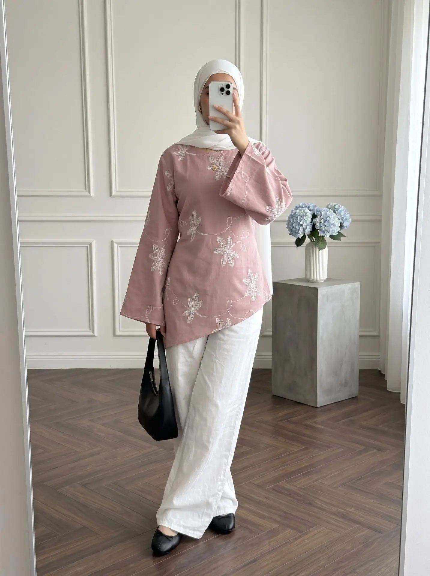 Elegant women's long-sleeve shirt featuring leaf embroidery, a round neck, and flared sleeves.