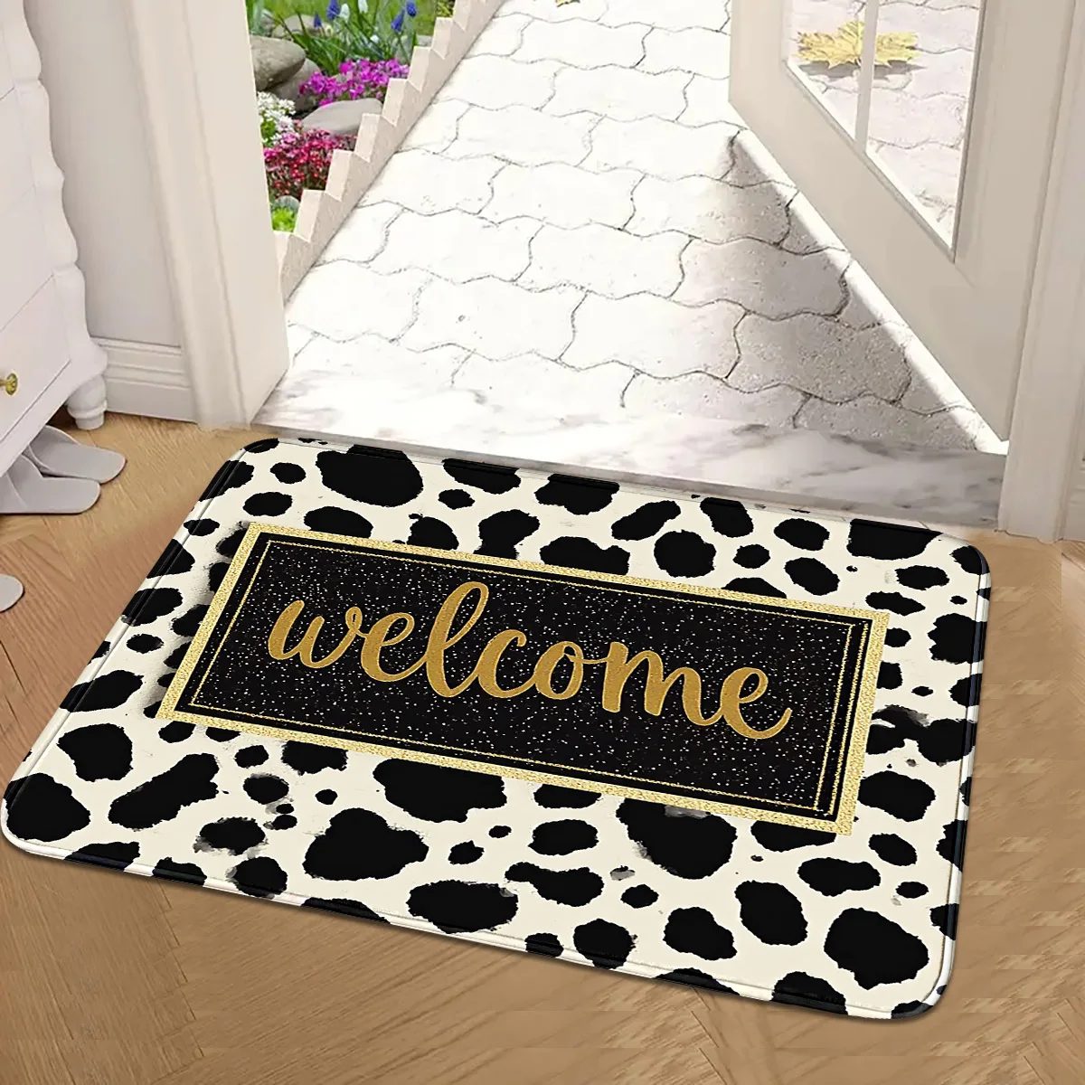 A Light Luxury Cow Pattern Welcome Entrance Mat with Black and Gold Edges, Non-Slip and Dust-Removing Doormat
