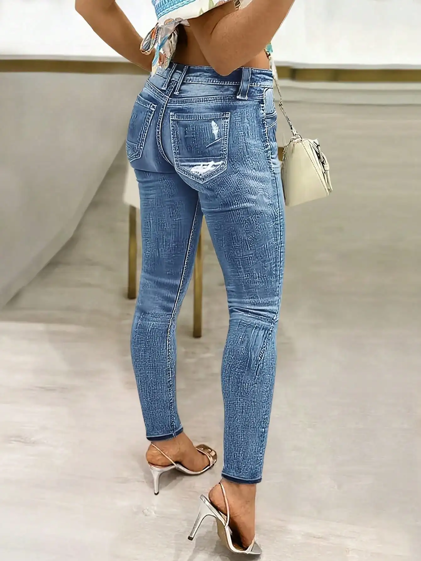 

Женские джинсы с высокой талией, эластичные, с эффектом подтяжки бедер и легкой текстурой, выполненные из денима с эффектом потертости.