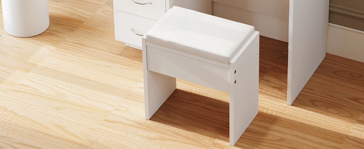 Small white wooden stool or side table with a drawer, placed on a hardwood floor next to a white baseboard.