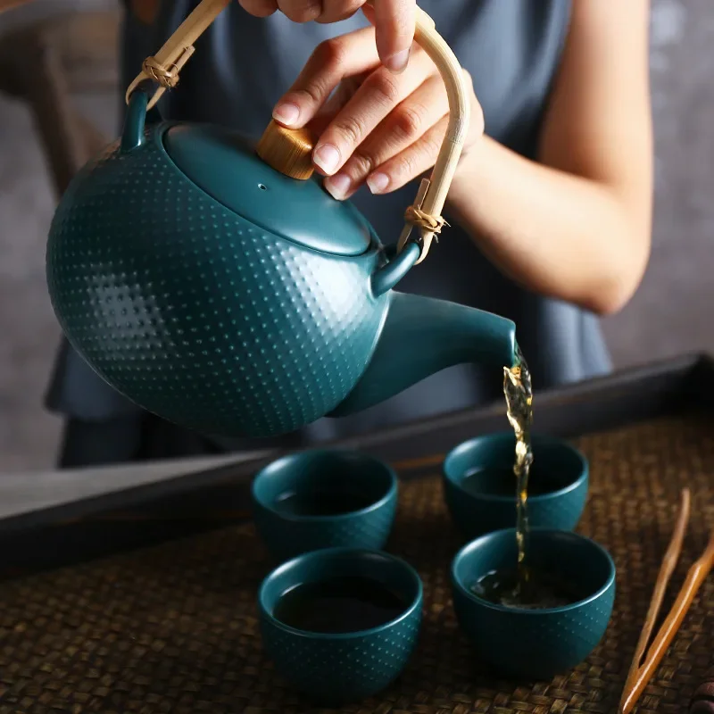 

Household ceramic tea set a pot of four cups set creative afternoon tea cups Kung Fu Camellia teapot