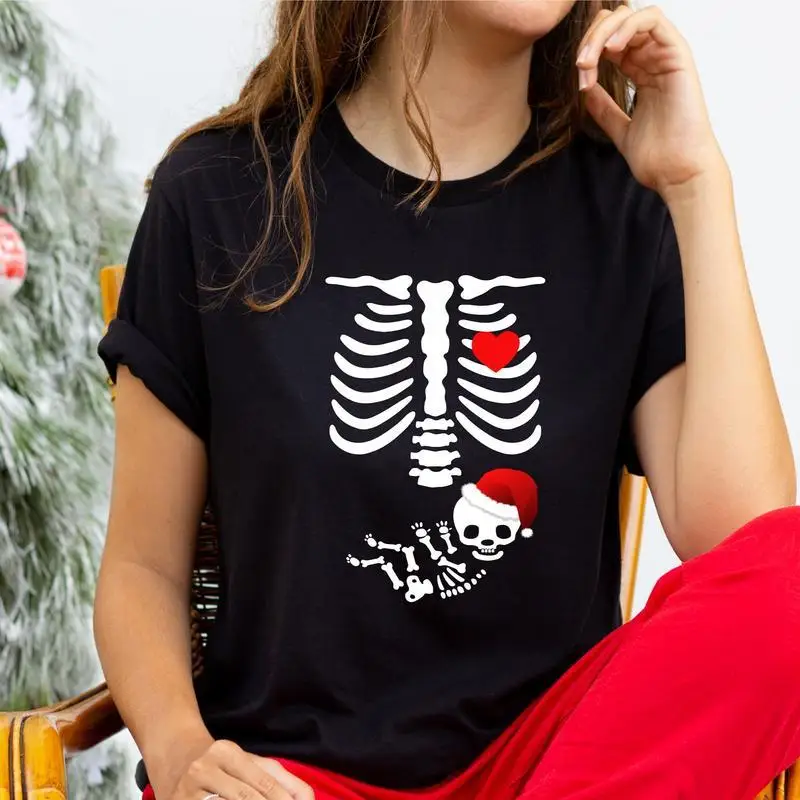 

Pregnant Christmas Skeleton Shirt, Christmas Maternity Party 2023 T-Shirt, Pregnancy Announcement Tee, Mom To Be Shirt.