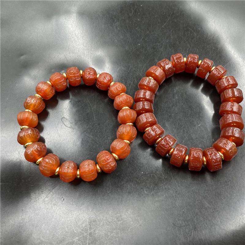 

Red agate abacus bead bracelet with intricate patterns and multi-faceted edges
