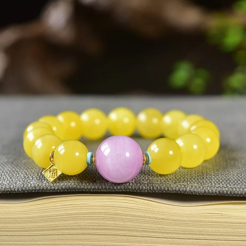 Natural Russian bracelet with a single strand of amber beads featuring a 12mm purple lithium feldspar bead made from raw