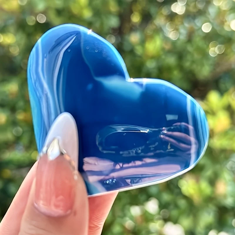 A handcrafted blue agate heart-shaped crystal palm stone, a unique specimen suitable for collection and educational purposes