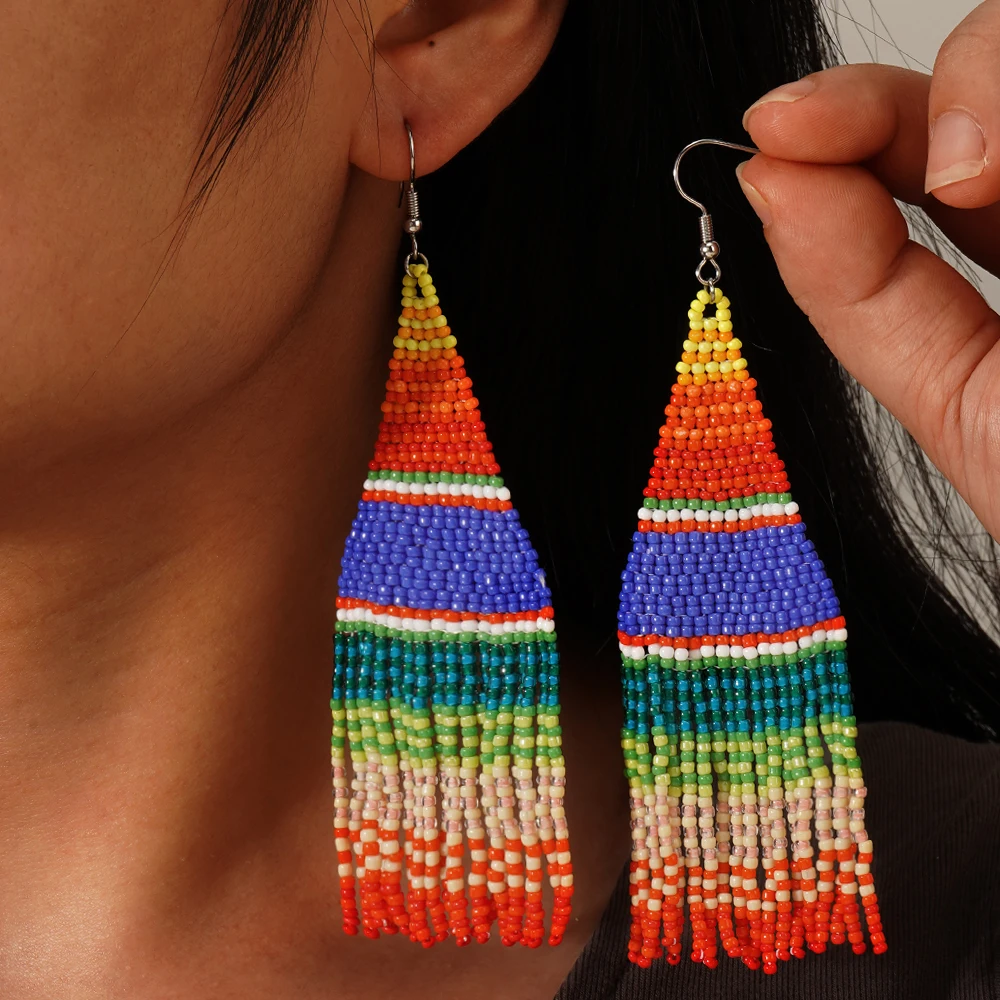 A pair of colorful striped Bohemian vacation style Su Mi bead woven earrings, hand woven earrings accessories
