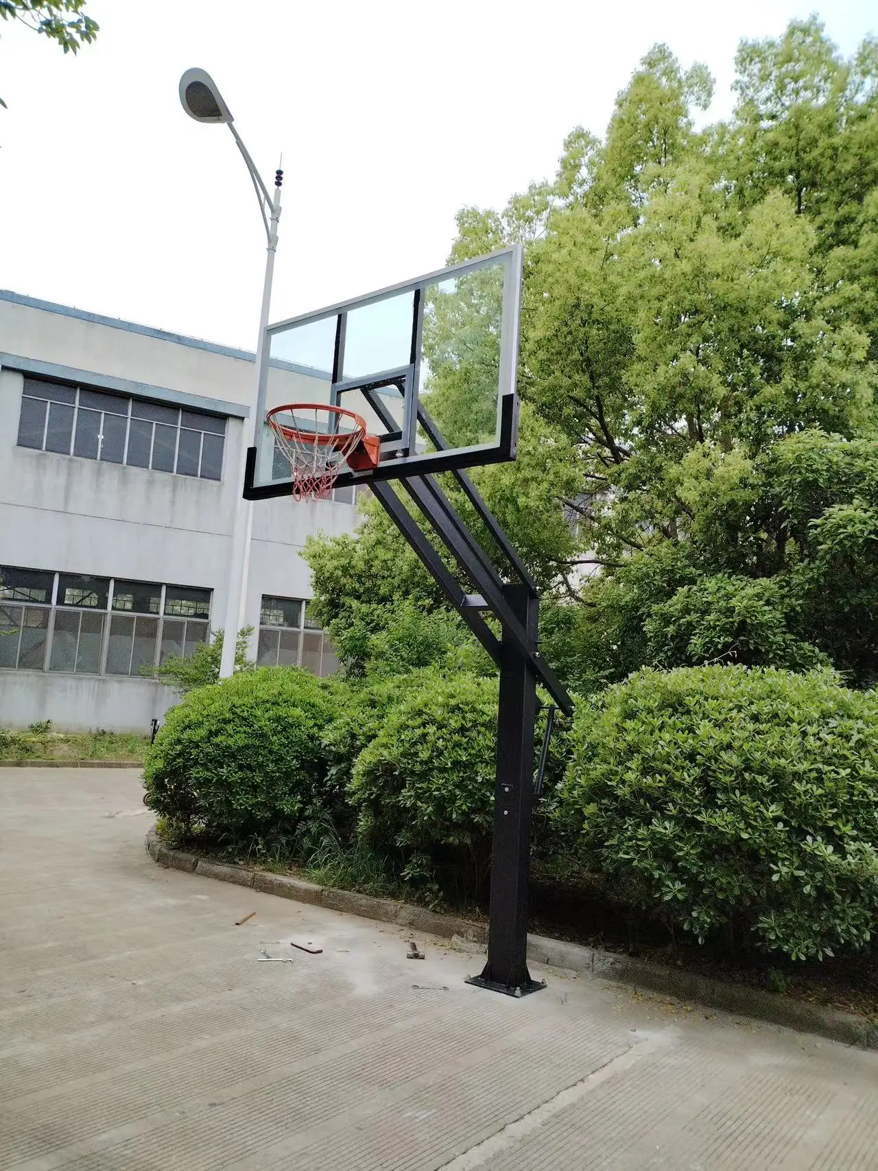 Outdoor in ground basketball pole with pole padding  tempered glass height adjustable system  professional basketball hoop stand