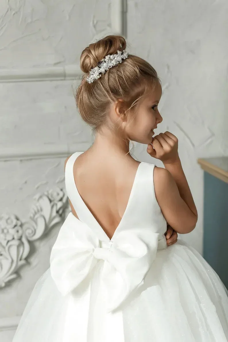 

Custom White Flower Girl Dress for Wedding First Christmas Party with Sleeveless V Back Large Satin Bow and Sparkly Tulle Ball