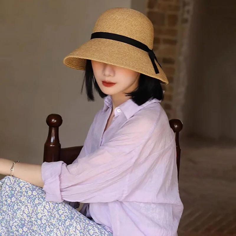 Designer fine grass woven straw hat female bow sun hat seaside holiday fisherman hat foldable Joker travel.