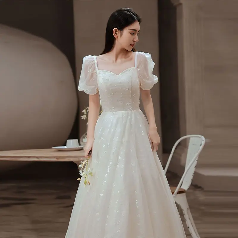 فستان سهرة أبيض متخصص نمط جديد مأدبة خرافية مزاجه الراقية نمط طويل الاجتماع السنوي استضافة فستان المرأة الربيع