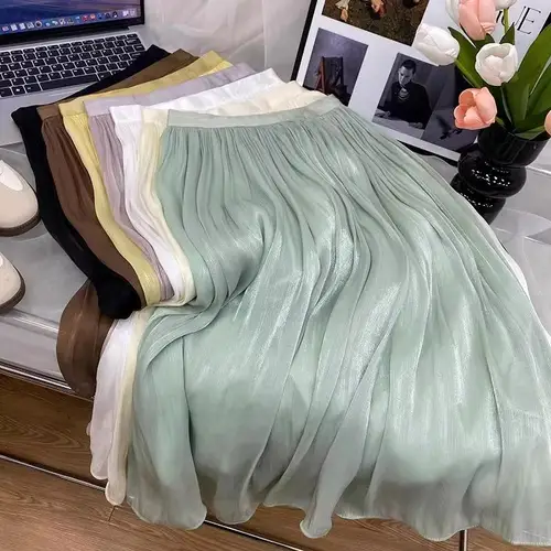 Imagen 1 del producto 2025 Primavera/Novedad de verano brillo A-line falda de mujer Color sólido cintura alta estilo francés París elegante falda asimétrica