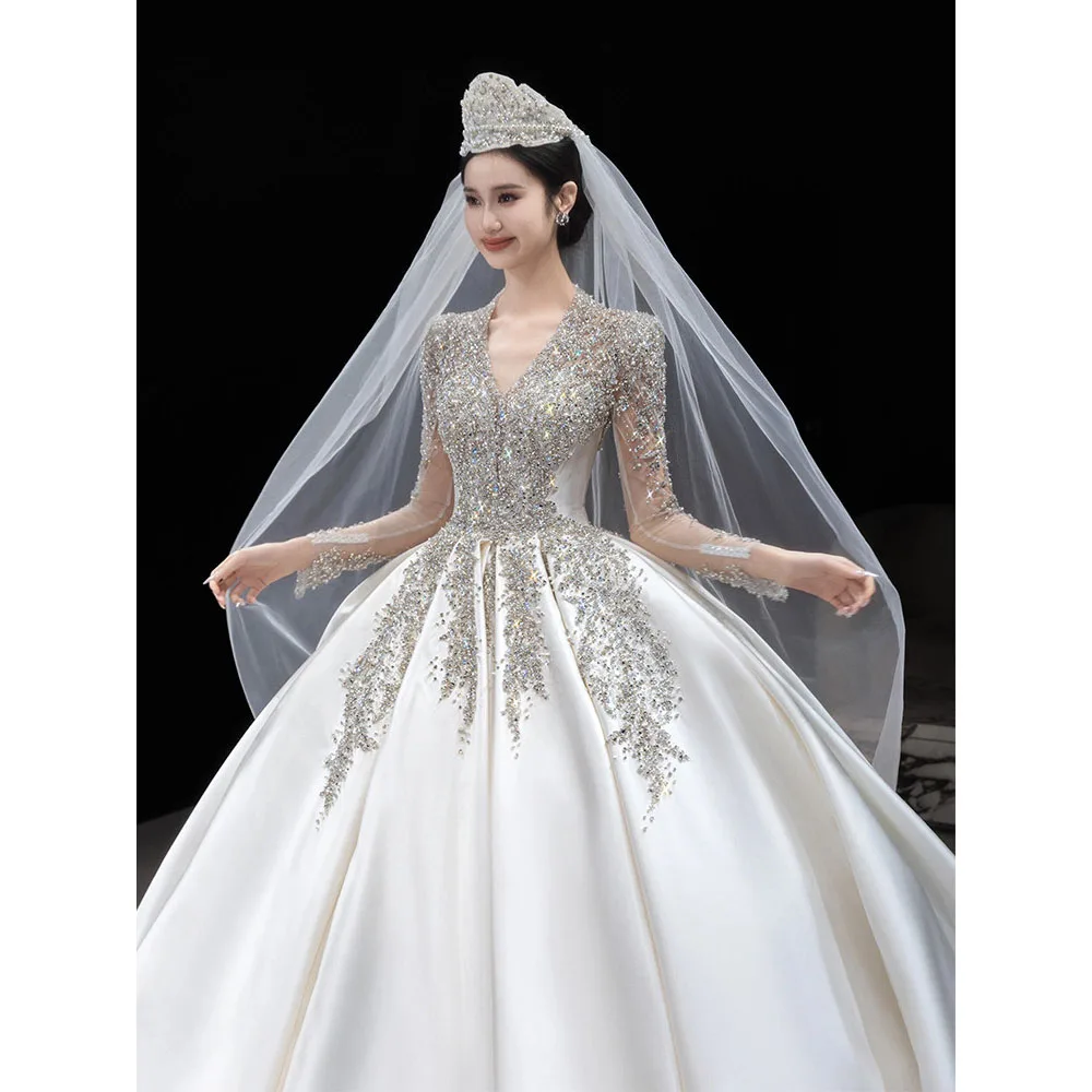 Luxury Crystal Beaded Long Sleeve Wedding Dress 2026 Satin Ball Gown Princess Cathedral Train Bridal Gowns