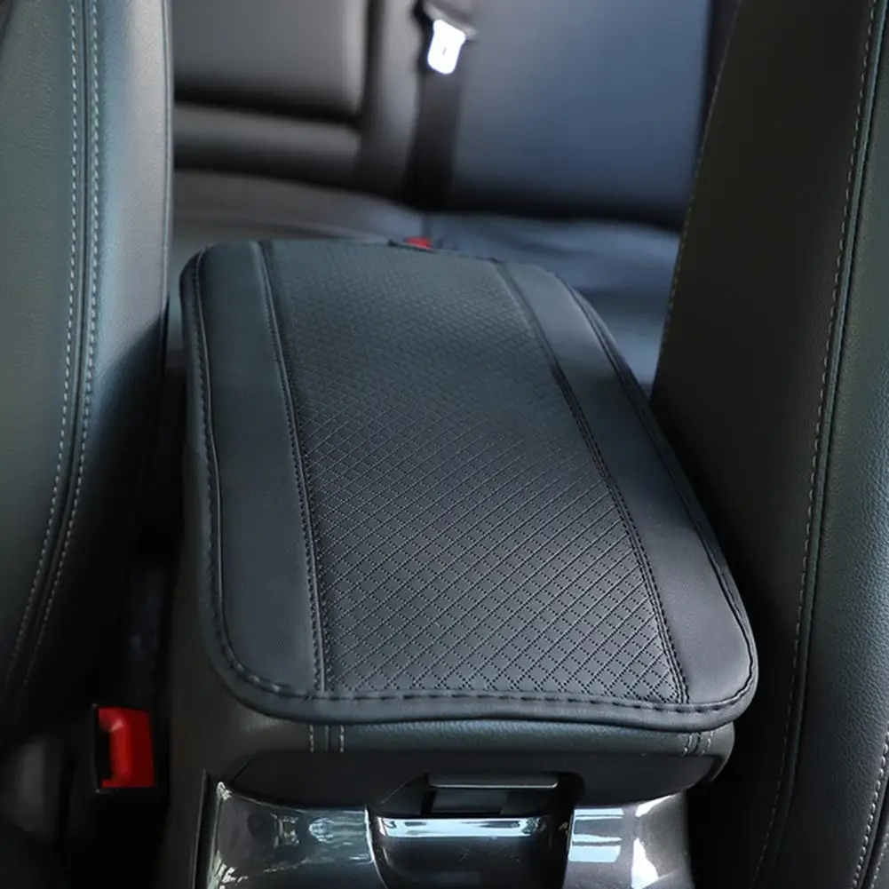 This car armrest mat features a three-dimensional embossed design and tight stitching for decorative purposes.