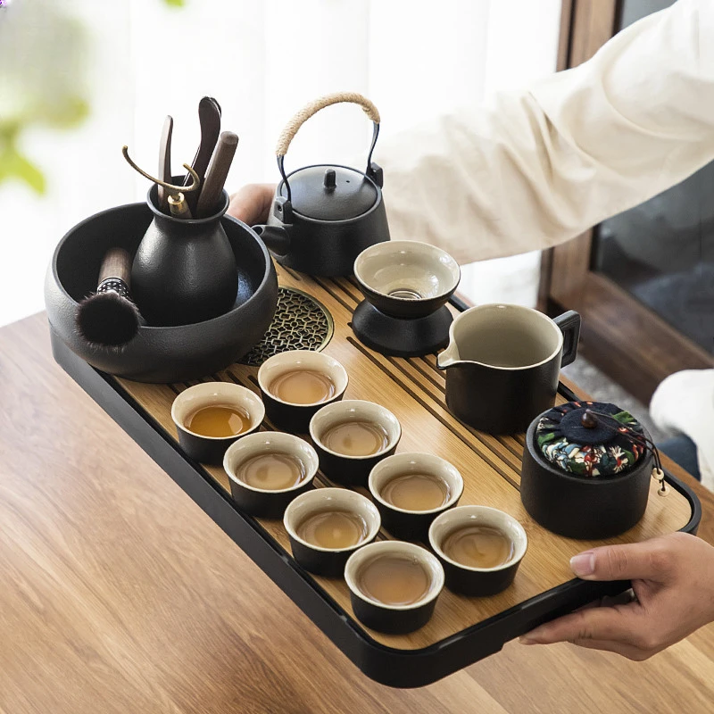 

Japanese black pottery Kung Fu tea set retro simple teapot eight cups dual-purpose tea tray for water storage.