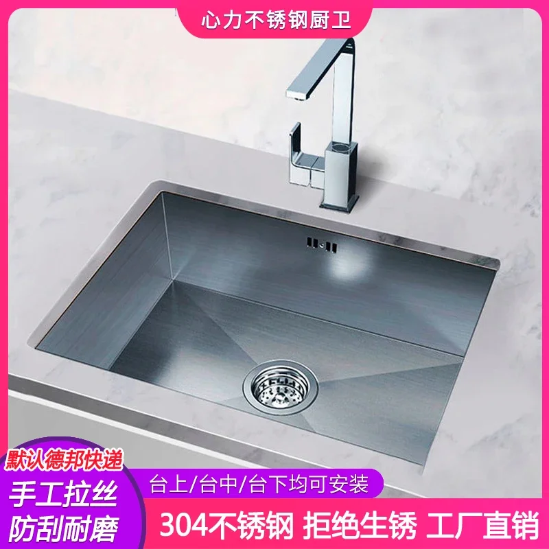 

Narrow edged brushed stainless steel sink with single slot embedded in the middle of table and under the sink in the kitchen