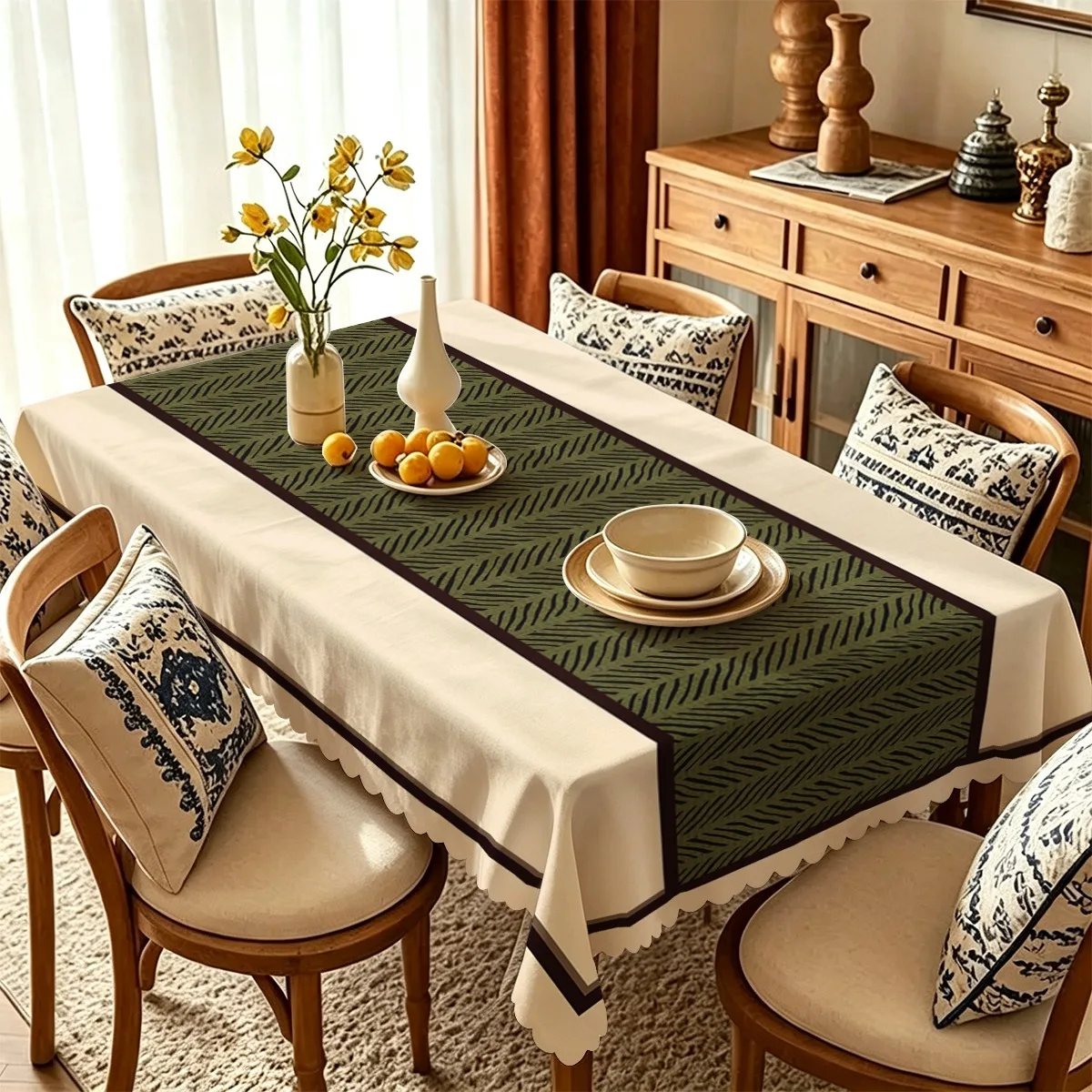 A rectangular tablecloth with a light beige background and an olive green zigzag pattern along the middle as the border