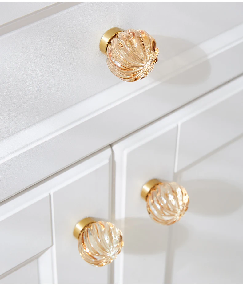 Champagne ribbed knobs on a white cabinet